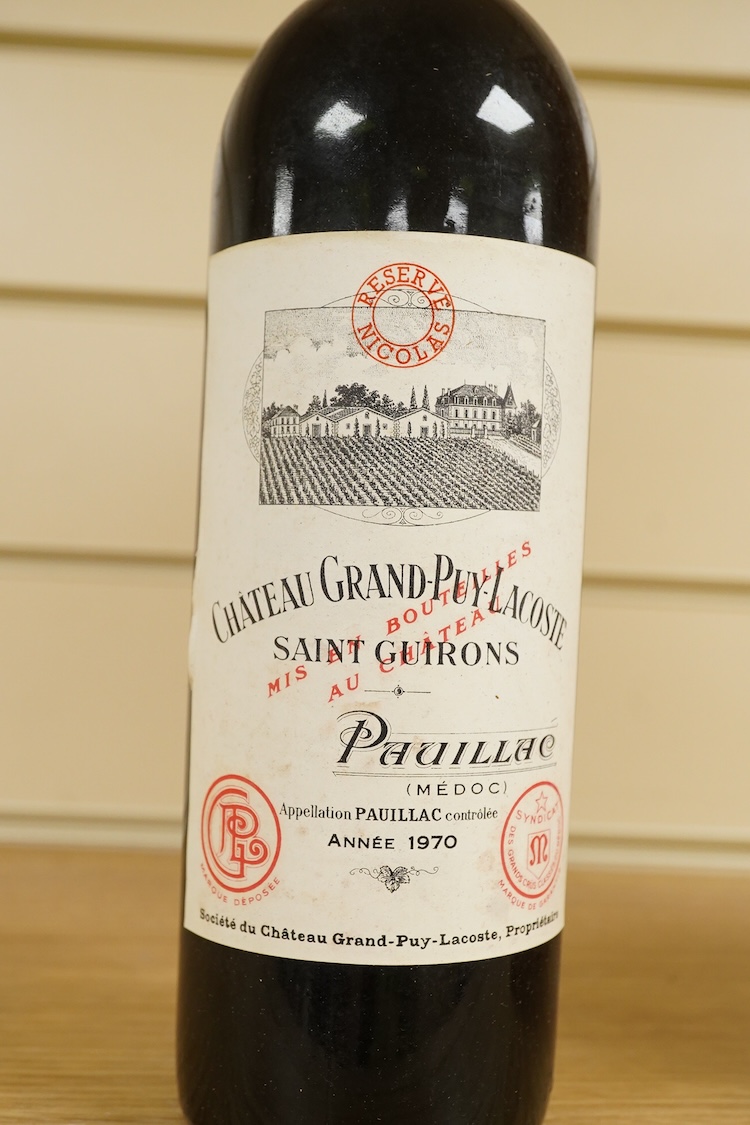 A bottle of Fonseca 1970 vintage port, a bottle of 1970 Chateau Grand-Puy-Lacoste, a litre bottle of Bounty rum and a litre bottle of Harvey’s Bristol Cream